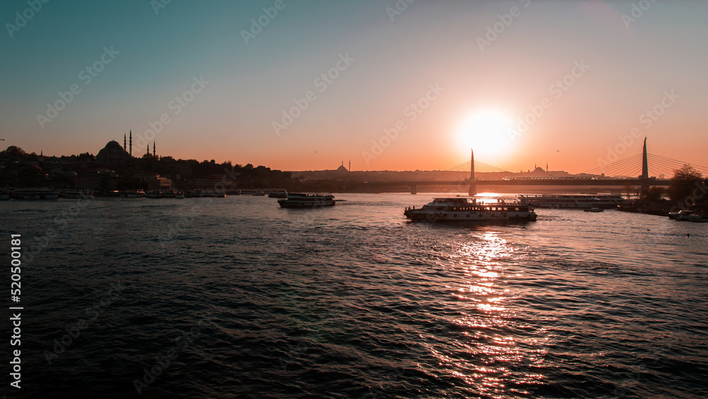 Istanbul City sunset and skyline view of the city. Steamers, birds, sky, mosque, sunset, sunrise, bridge, seagull,sea.