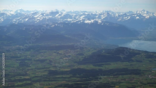 Swiss countryside and part of the Geneva (Leman) lake with the Alps in the background, aerial view