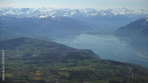 Swiss countryside and part of the Geneva (Leman) lake with the Alps in the background, aerial view