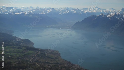 Swiss countryside and part of the Geneva (Leman) lake with the Alps in the background, aerial view