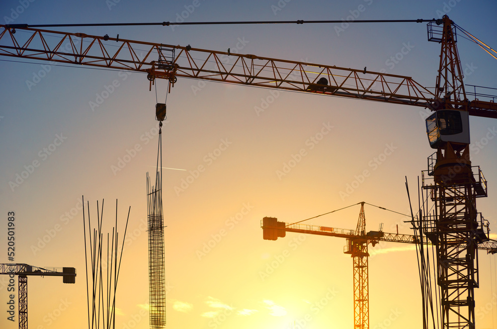 Silhouette of modern construction site during summer sunset