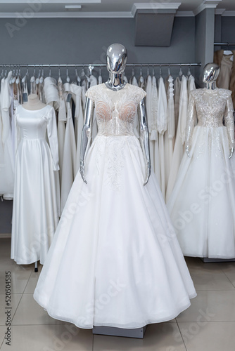 Wedding gowns on display at modern bridal shop showroom