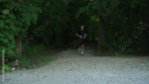 Wallpaper Mural Male runner jogging at park. Sport wearing man running outdoors. Fitness, cardio and healthy lifestyle concept Torontodigital.ca