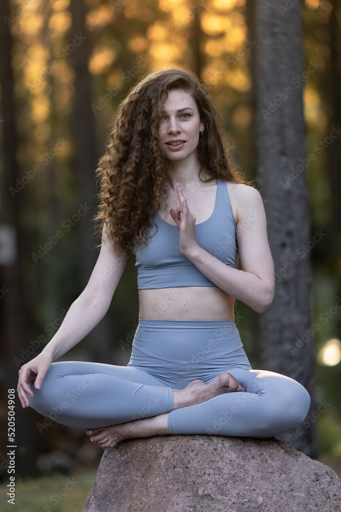 Beautiful girl meditating, yoga meditation practice in nature.