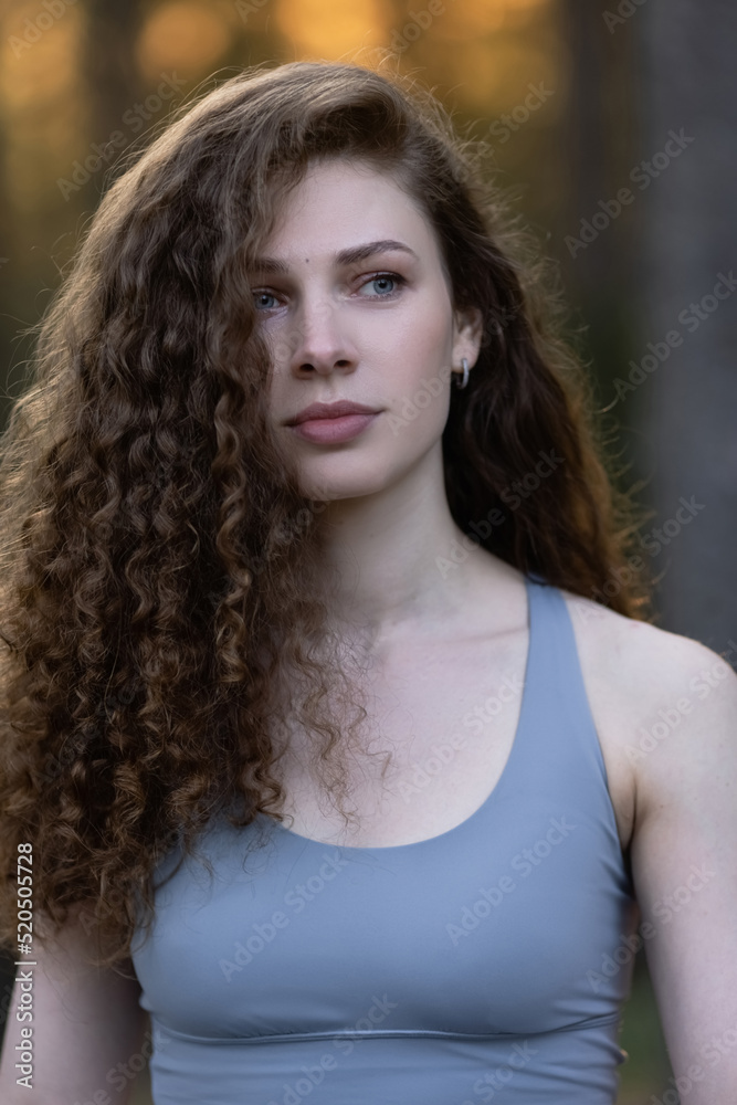 Young, beautiful skinny brunette posing in a forest grove. Young country girl in a classic sundress Young, beautiful skinny brunette posing in a forest grove. Young country girl in a classic sundress