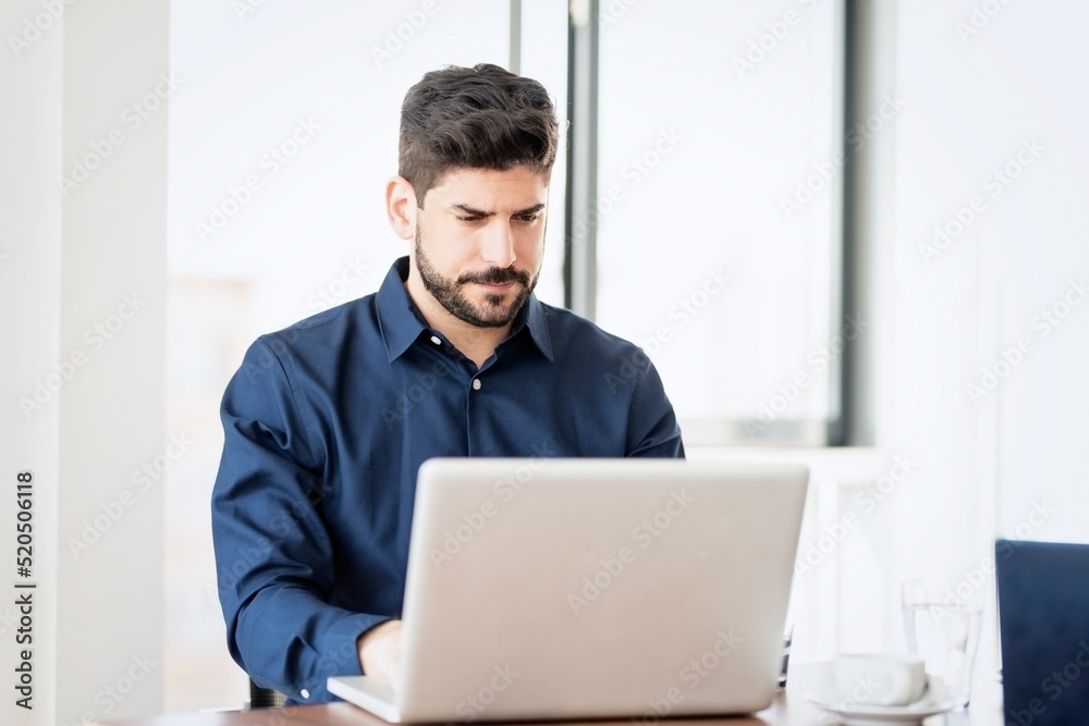 Businessman sitting at desk and working in the office Businessman sitting at desk and working in the office