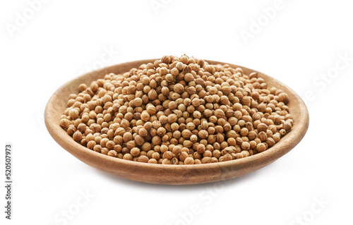 dry coriander seed spice on a wood plate isolated on white background. dry coriander seed on a wooden plate or dish isolated on white background. coriander seed food isolated background 