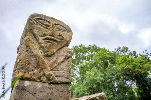 This is a bronze age stone carviing with two faces,called Janus, located In Caldragh Cemetery on Boa Island, Lower Lough Erne. Northern Ireland photo