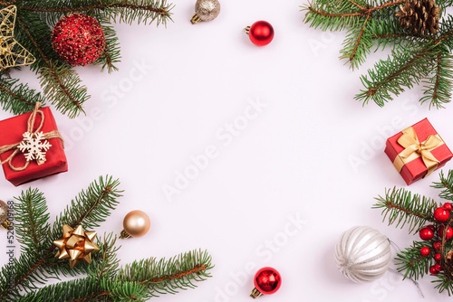 Christmas background, fir branches, gift boxes, red balls and Christmas decorations on white background. Top view, flat lay, copy space