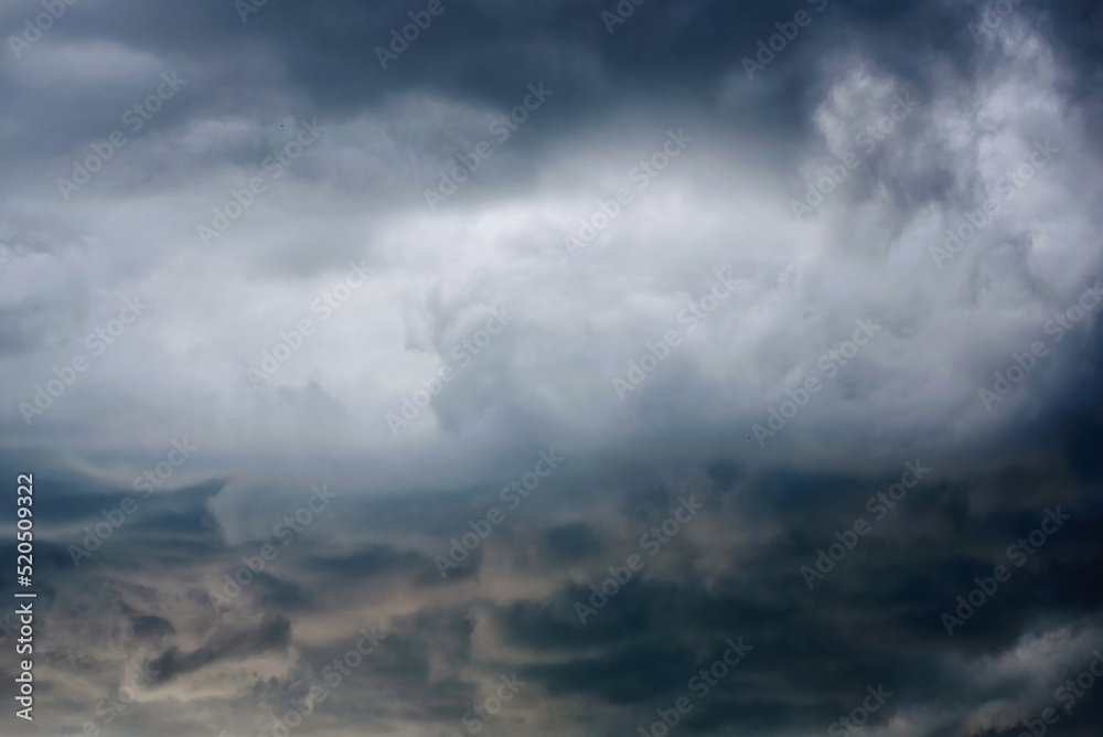 Storm clouds in the sky. Stormy sky background with gray clouds before rain. Weather forecast concept. Dark thunderstorm clouds and shining clouds, cloudscape. Stormcloud in the sky. Blur effect Storm clouds in the sky. Stormy sky background with gray clouds before rain. Weather forecast concept. Dark thunderstorm clouds and shining clouds, cloudscape. Stormcloud in the sky. Blur effect