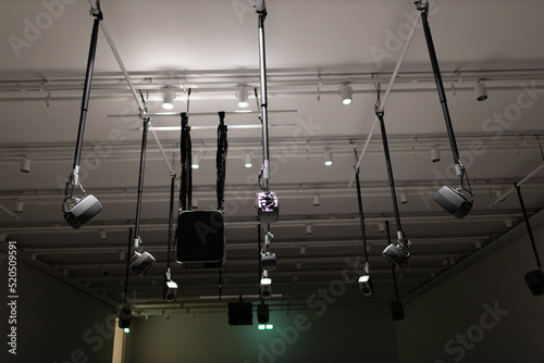 Young man listening to sound music surround installation with many speakers above