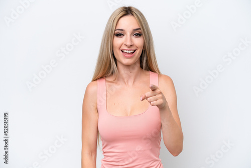 Pretty blonde woman isolated on white background surprised and pointing front