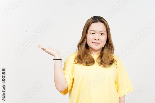 Showing and Presenting Product on Open Palm of Beautiful Asian Woman wearing yellow T-Shirt © Sino Images Studio