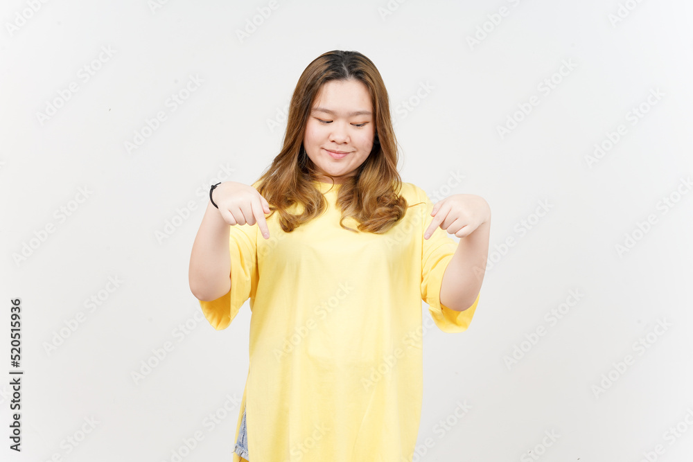 Pointing down and showing blank copy space of Beautiful Asian Woman wearing yellow T-Shirt Pointing down and showing blank copy space of Beautiful Asian Woman wearing yellow T-Shirt