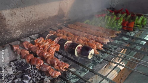 Adana kebab and chicken shish on the grill.
Adana kebab and chicken wings are cooked on the grill.
 photo