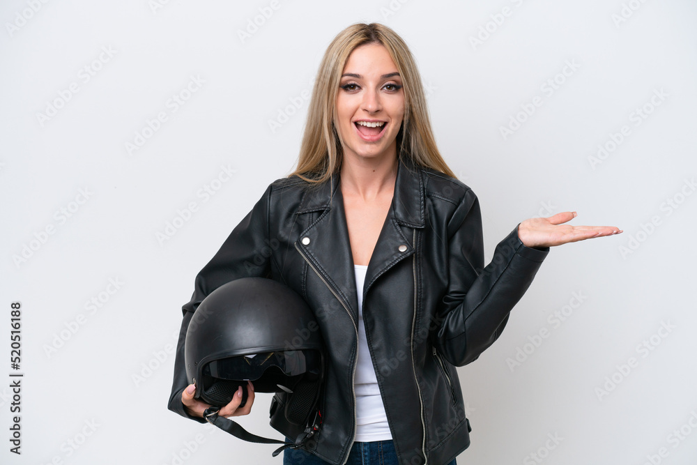 Pretty blonde woman with a motorcycle helmet isolated on white background with shocked facial expression Pretty blonde woman with a motorcycle helmet isolated on white background with shocked facial expression