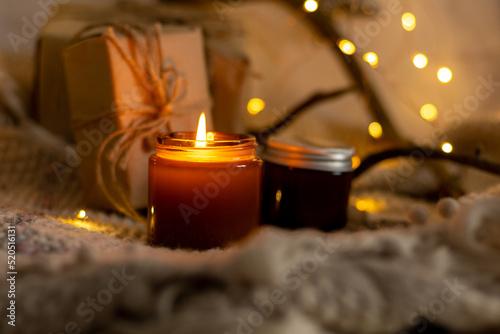A set of different aroma candles in brown glass jars. Scented handmade candle. Soy candles are burning in a jar. Aromatherapy and relax in spa and home.