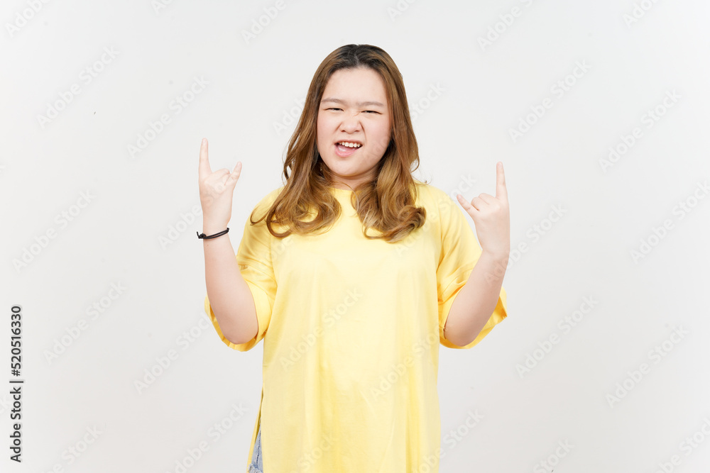 Showing Metal hands of Beautiful Asian Woman wearing yellow T-Shirt Isolated On White Background Showing Metal hands of Beautiful Asian Woman wearing yellow T-Shirt Isolated On White Background