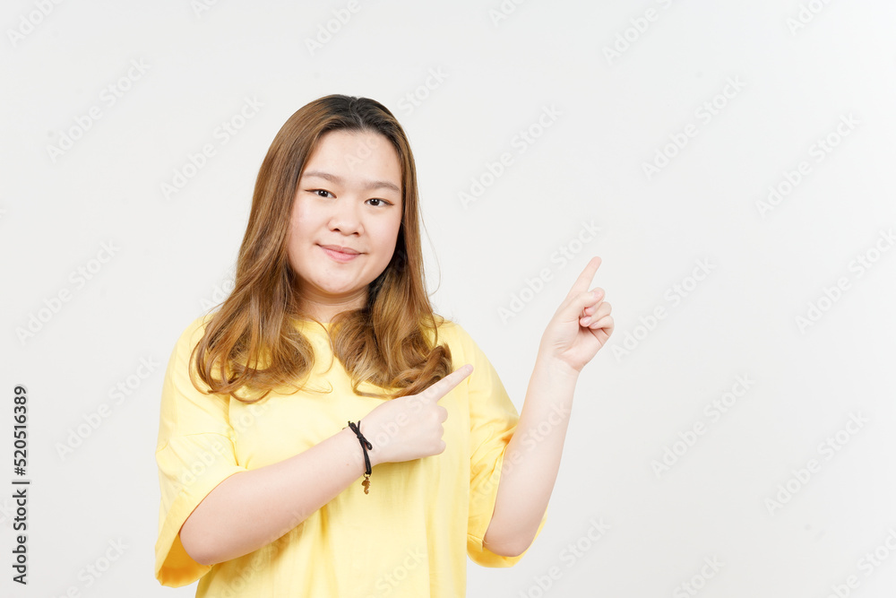 Showing Product and Pointing Side of Beautiful Asian Woman wearing yellow T-Shirt Isolated On White Showing Product and Pointing Side of Beautiful Asian Woman wearing yellow T-Shirt Isolated On White