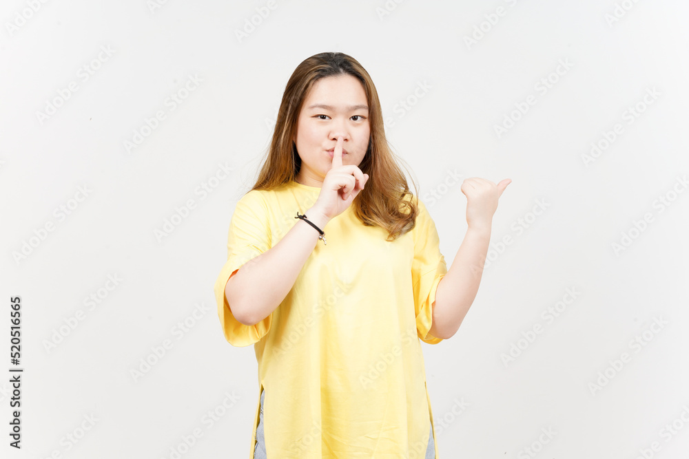 Shh gesture, Presenting and Pointing Side Product Using Thumb of Beautiful Asian Woman Shh gesture, Presenting and Pointing Side Product Using Thumb of Beautiful Asian Woman