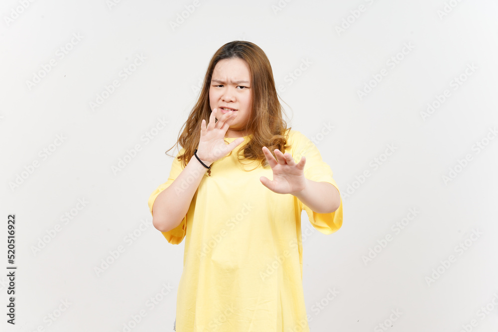 Stop hand rejection gesture of Beautiful Asian Woman wearing yellow T-Shirt Isolated On White Stop hand rejection gesture of Beautiful Asian Woman wearing yellow T-Shirt Isolated On White