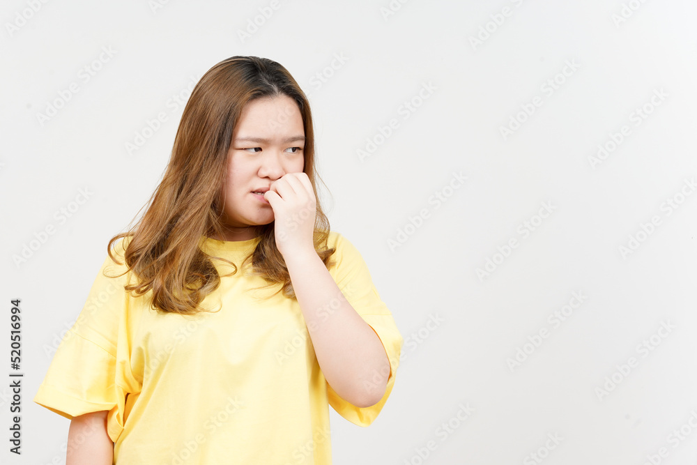 Afraid , nervous and bite nails of Beautiful Asian Woman wearing yellow T-Shirt Isolated On White Afraid , nervous and bite nails of Beautiful Asian Woman wearing yellow T-Shirt Isolated On White