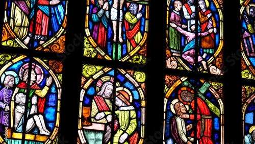 Old antique colorful stained glass windows in a darkened church, saints, bible scenes religious art decoration detail, closeup, nobody Christianity, christian art symbols
