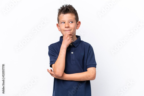 Little caucasian boy isolated on white background thinking an idea while looking up