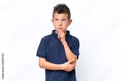 Little caucasian boy isolated on white background having doubts and thinking