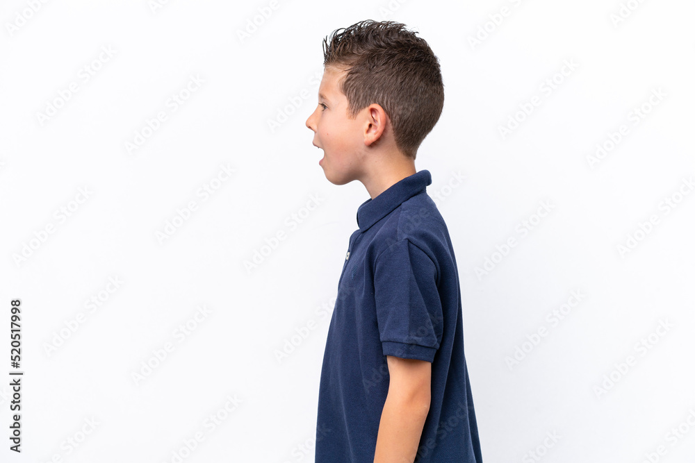 Little caucasian boy isolated on white background laughing in lateral position Little caucasian boy isolated on white background laughing in lateral position
