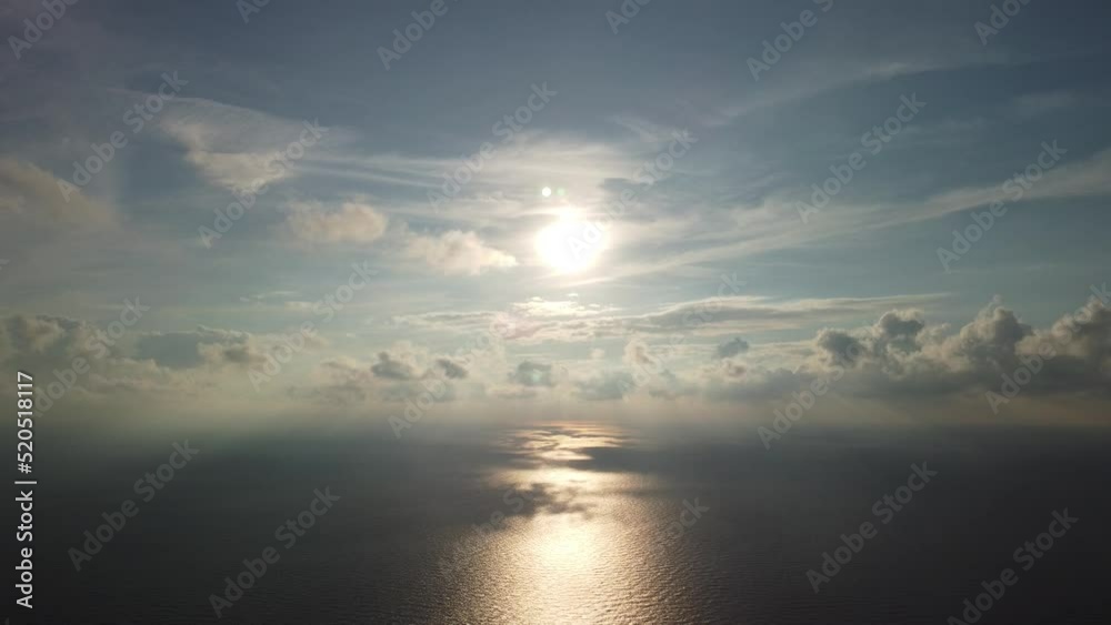 Abstract aerial nature summer ocean sunset sea and sky background. Small waves on clear water surface in motion blur with bokeh lights from sunrise. Holiday, vacation and recreational concept Abstract aerial nature summer ocean sunset sea and sky background. Small waves on clear water surface in motion blur with bokeh lights from sunrise. Holiday, vacation and recreational concept