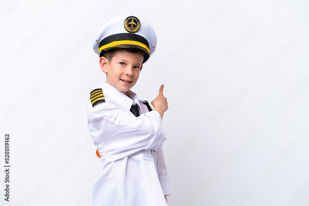 Little airplane pilot boy isolated on white background pointing back Little airplane pilot boy isolated on white background pointing back