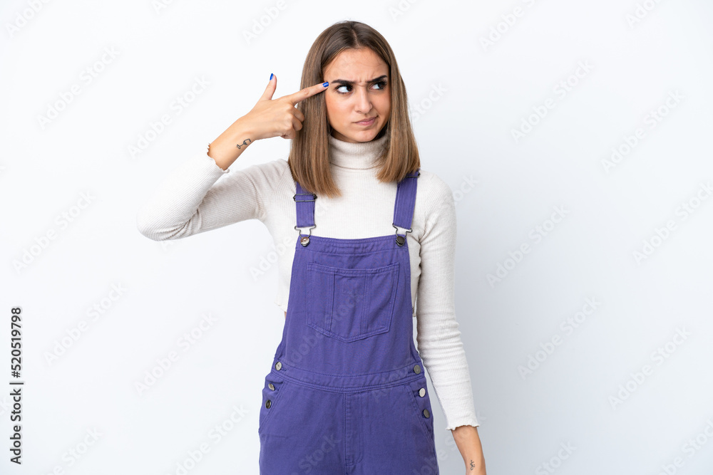 Young caucasian woman isolated on white background making the gesture of madness putting finger on the head Young caucasian woman isolated on white background making the gesture of madness putting finger on the head