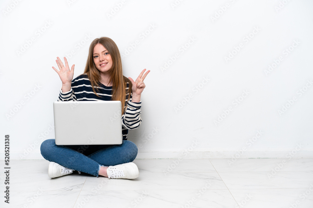 Young caucasian woman with a laptop sitting on the floor isolated on white background counting eight with fingers Young caucasian woman with a laptop sitting on the floor isolated on white background counting eight with fingers
