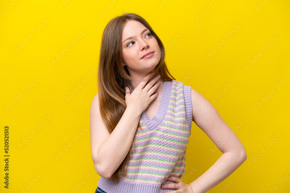 Young caucasian woman isolated on yellow background looking up while smiling Young caucasian woman isolated on yellow background looking up while smiling