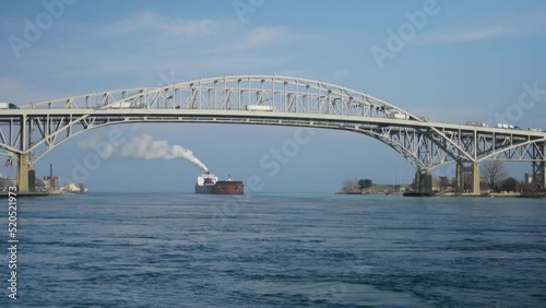 Large Great Lakes Freighter passing under the Blue Water Bridge that links Port Huron, Mich. and Sarnia Ontario photo