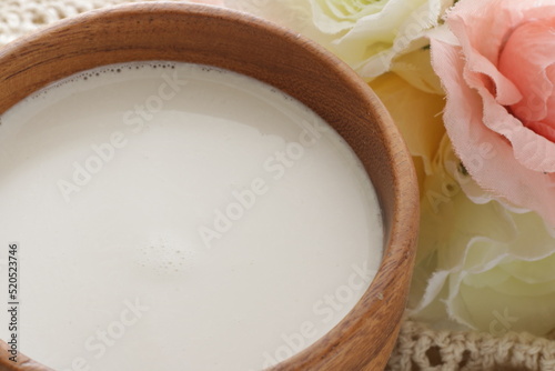 coconut milk in wooden bowl with copy space 