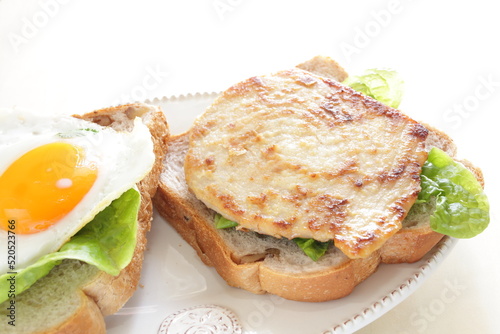 Pan fried Swordfish fillet and fried egg in sandwich for homemade breakfast