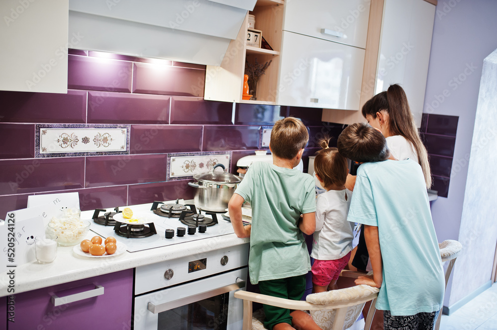 Mother with kids cooking at kitchen, happy children's moments. Mother with kids cooking at kitchen, happy children's moments.