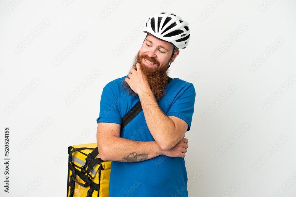 Young reddish caucasian man with thermal backpack isolate don white background looking to the side and smiling Young reddish caucasian man with thermal backpack isolate don white background looking to the side and smiling