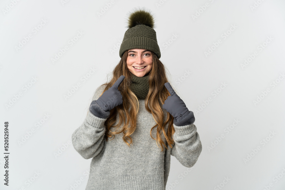 Young caucasian woman with winter hat isolated on white background giving a thumbs up gesture Young caucasian woman with winter hat isolated on white background giving a thumbs up gesture