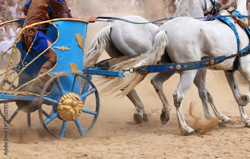 Detail of a roman chariot drawn by horses performing a race in the circus during the Arde Lucus traditional festival in Lugo, Galicia, Spain.