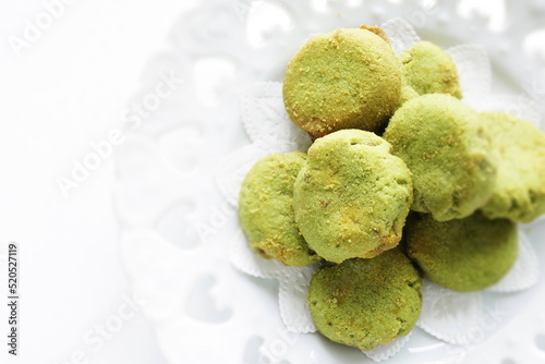 Pistachio cookie on white dish with copy space 