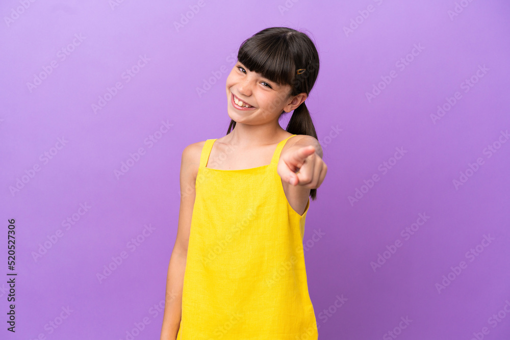 Little caucasian kid isolated on purple background pointing front with happy expression Little caucasian kid isolated on purple background pointing front with happy expression