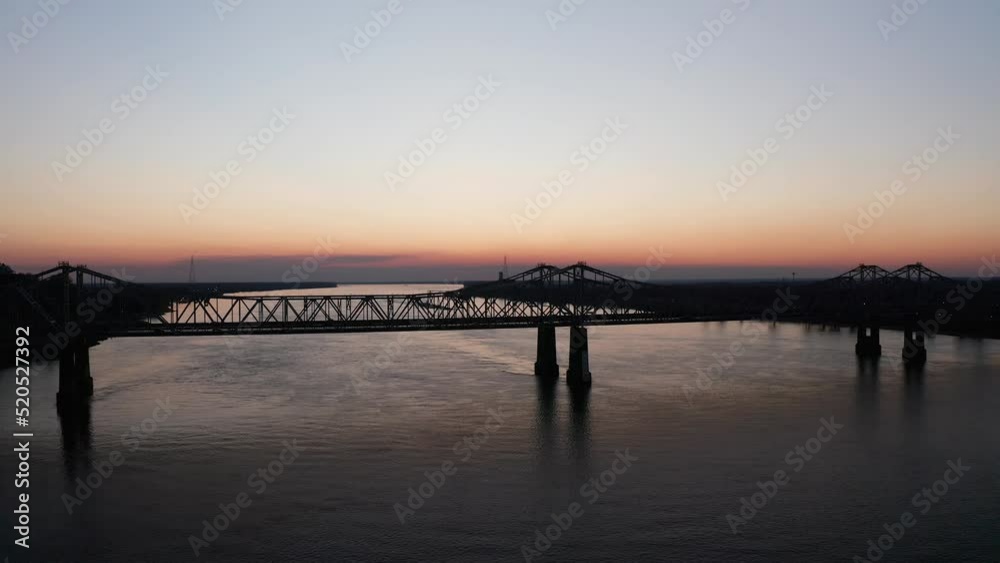 Low aerial shot flying over the Natchez-Vidalia Bridge on the Mississippi River at sunset. 4K Low aerial shot flying over the Natchez-Vidalia Bridge on the Mississippi River at sunset. 4K