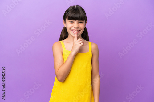 Little caucasian kid isolated on purple background showing a sign of silence gesture putting finger in mouth