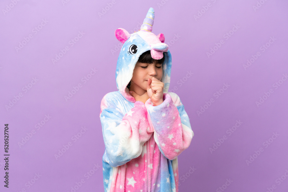 Little kid wearing a unicorn pajama isolated on purple background is suffering with cough and feeling bad