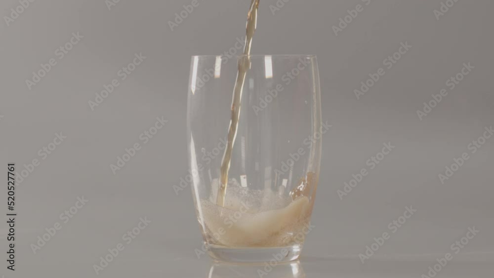 Glass being filled with cola drink and foaming in slow motion - 240 fps Glass being filled with cola drink and foaming in slow motion - 240 fps