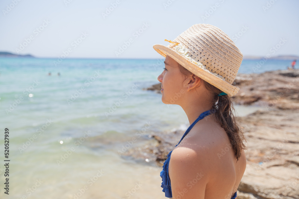 Summer holiday travel portrait. Child girl with straw hat looking seascape. Summer holiday travel portrait. Child girl with straw hat looking seascape.