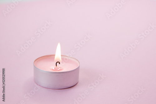 pink candle on a dark background